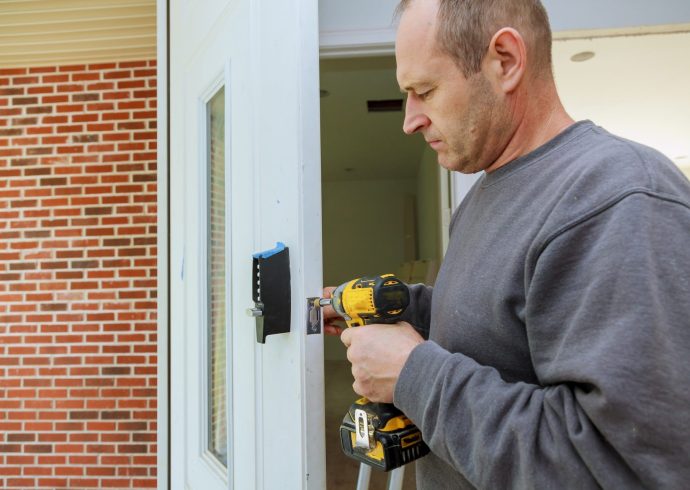 installation-locked-interior-door-woodworker-hands-install-lock-installation-of-the-door-lock-e1641458140476