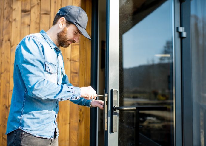 man-repairing-door-lock